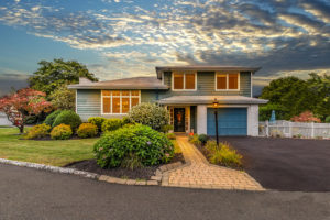 Professional photo editors tweaking real estate photos on a computer.